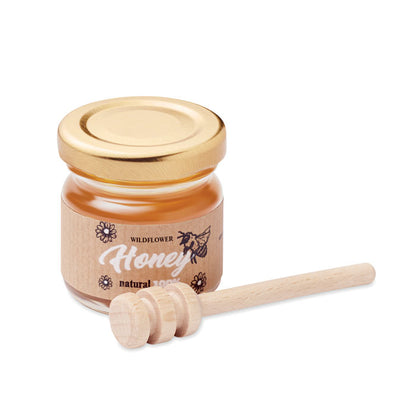 Tarro de miel con dispensador de madera y tapa dorada