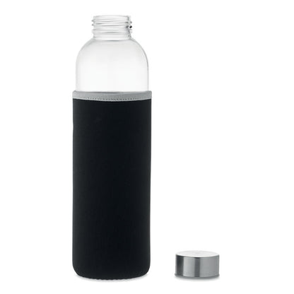 Botella de cristal con funda negra y tapa al lado