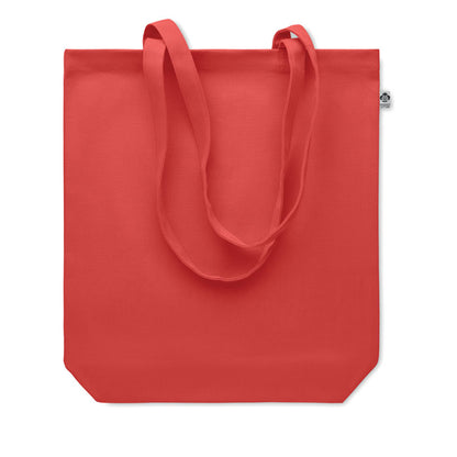 Bolsa roja de canvas con pequeña etiqueta de algodón orgánico cosida en el lateral y asas largas