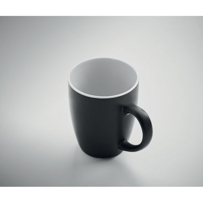 Taza redondeada de cerámica negra  y blanca