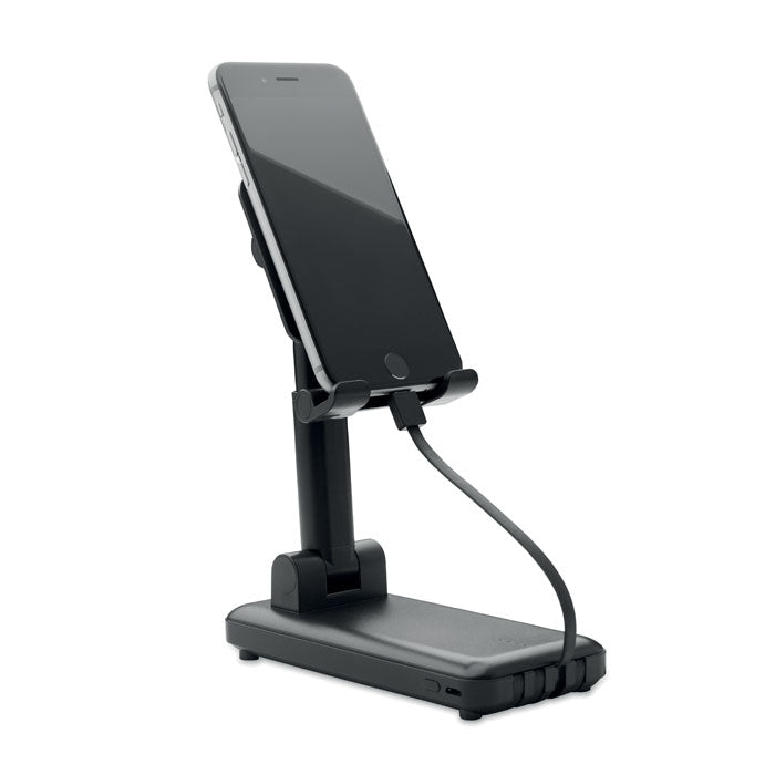 Soporte plegable ajustable para teléfono, con cable de carga, mostrando el AVELI - Powerbank 10000mAh 10W en uso.