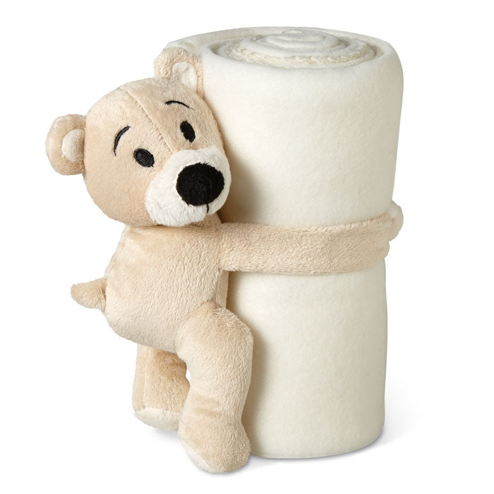 Osito de peluche abrazando una manta polar blanca enrollada, ideal para niños. Diseño tierno y acogedor.