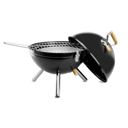 Barbacoa cilíndrica negra con tapa desmontada