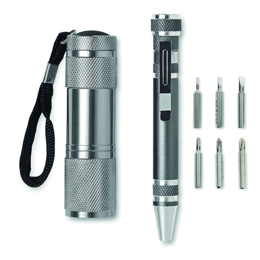 Conjunto de linterna de aluminio con 9 LED y bolígrafo multifuncional en titanio, junto a 6 cabezales de destornillador.