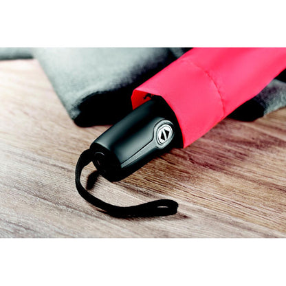Paraguas automático plegable rojo dentro de su funda