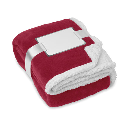 manta reversible de tejido grueso polar bicolor: rojo y blanco.  Envuelta en cinta  y con tarjeta blanca