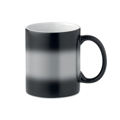 Taza de cerámica negra cambiando de color a blanca por el líquido caliente del interior