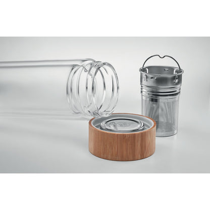 Botella tumbada de cristal con tapa de madera e infusor