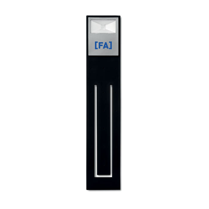 Vista frontal de luz de lectura LED flexible, con diseño estilizado y puntos de fijación tipo clip, color negro.