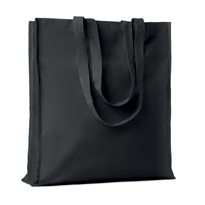 Bolsa de algodón negra con asas largas, confeccionada en material de 140 gr/m², ideal para compras.