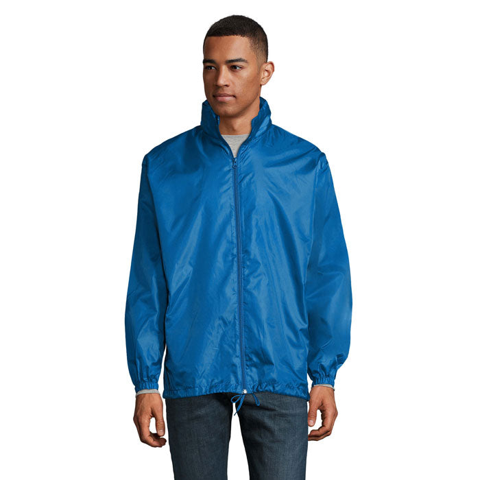 SHIFT - SHIFT CORTAVIENTO UNIX chaqueta cortaviento unisex de color azul, con cremallera y puños elásticos.