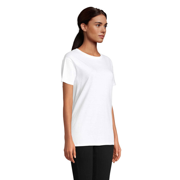 Modelo en vista lateral con camiseta blanca de algodón orgánico, corte ajustado y cuello redondo, ideal para un look casual.