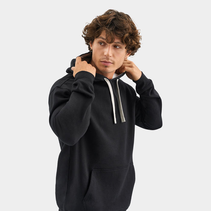 Vista de tres cuartos de modelo con sudadera negra y capucha con cordones claros