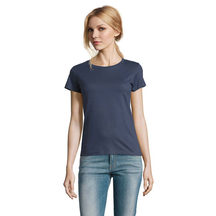 Modelo en camiseta de cuello redondo en color azul marino, fabricada en 100% algodón, combinada con jeans.